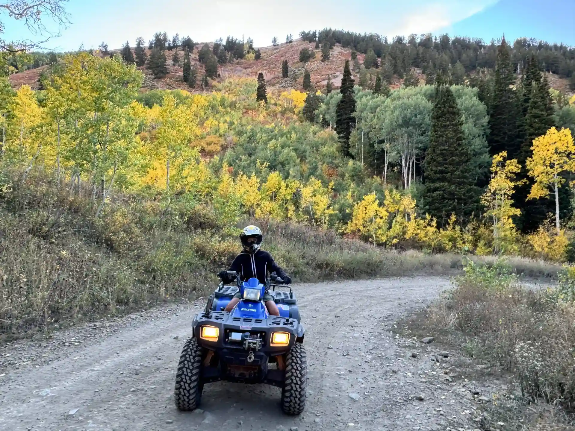 ATV riding along a country road with mountain views in Island Park