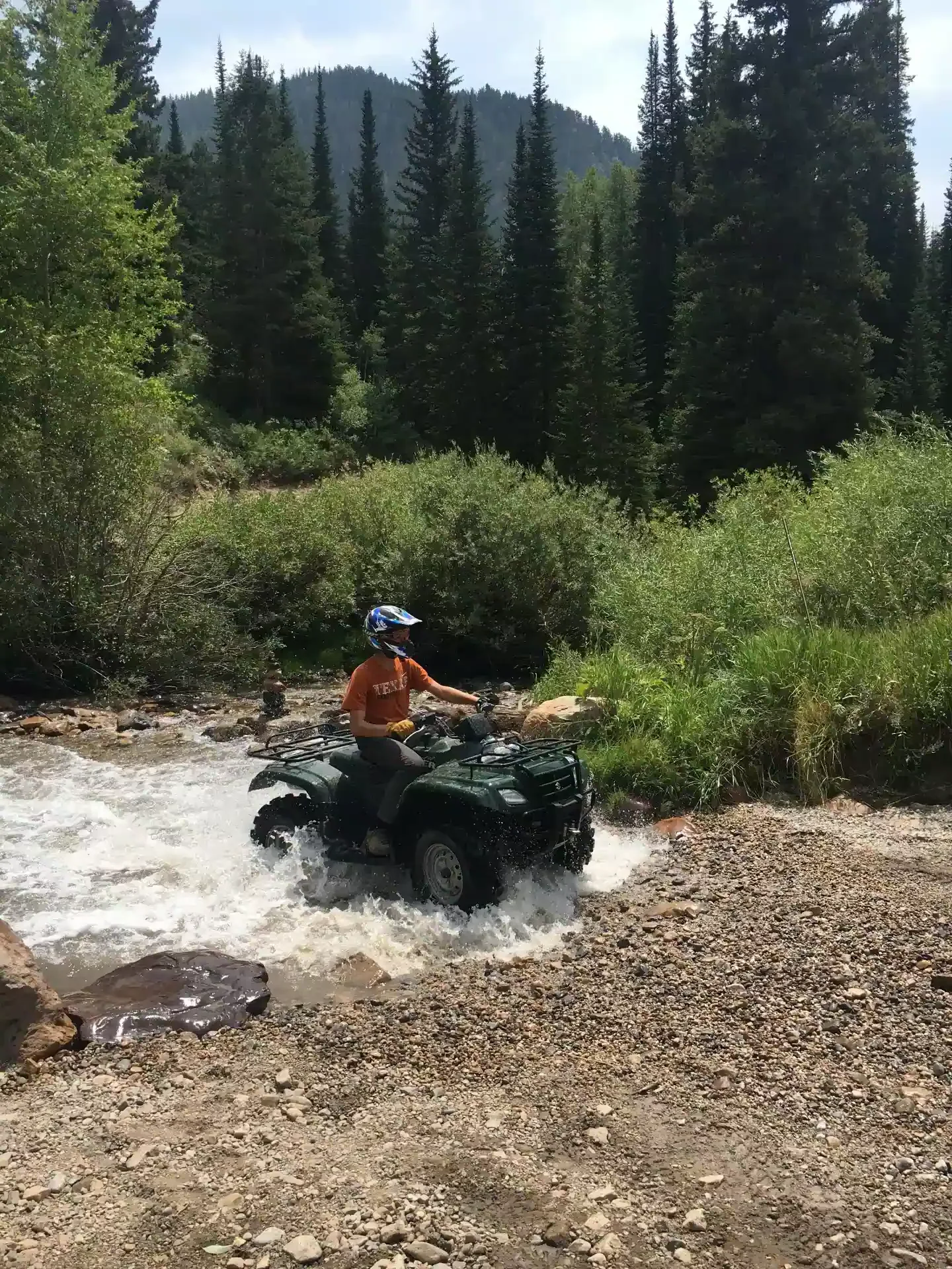 ATV rider crossing a stream in Island Park Idaho
