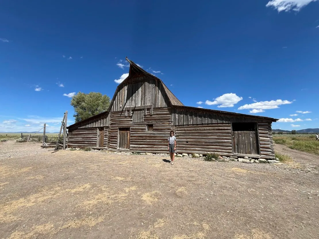 Visitor exploring the historic Mormon Row barns in Grand Teton National Park