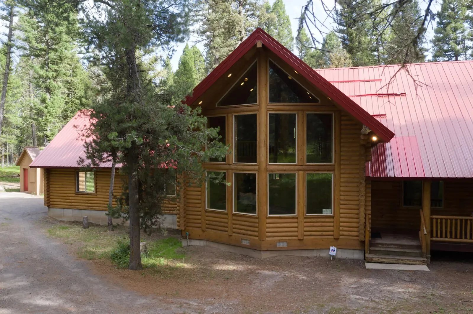 Front porch with log railing and mountain views
