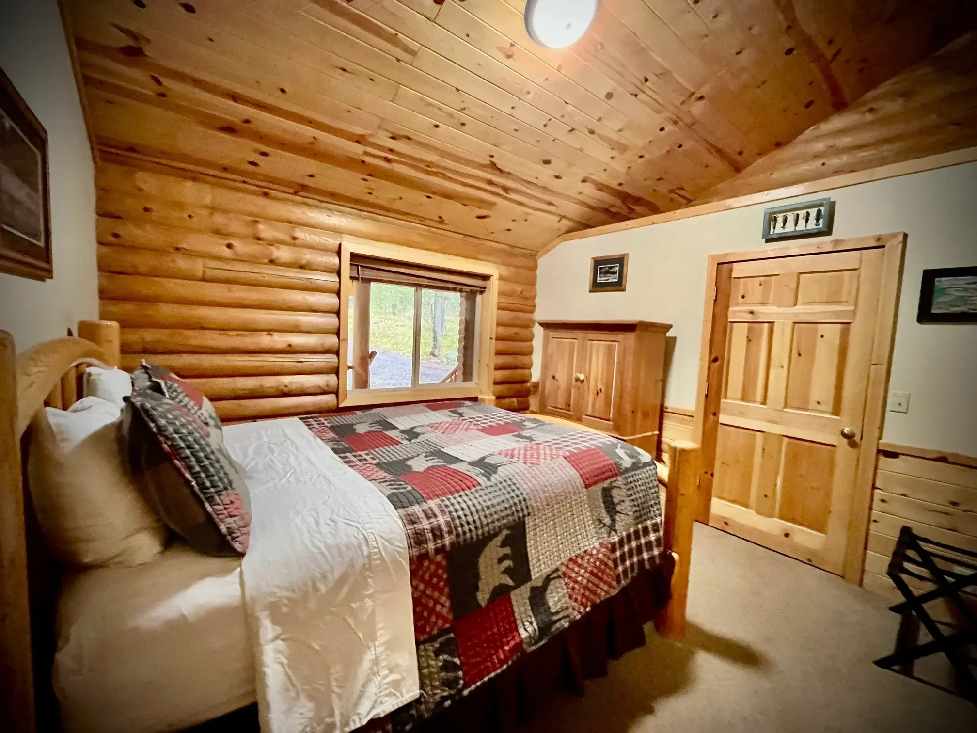 Another angle of the fish-themed room with a great view of the deck and wooded forest