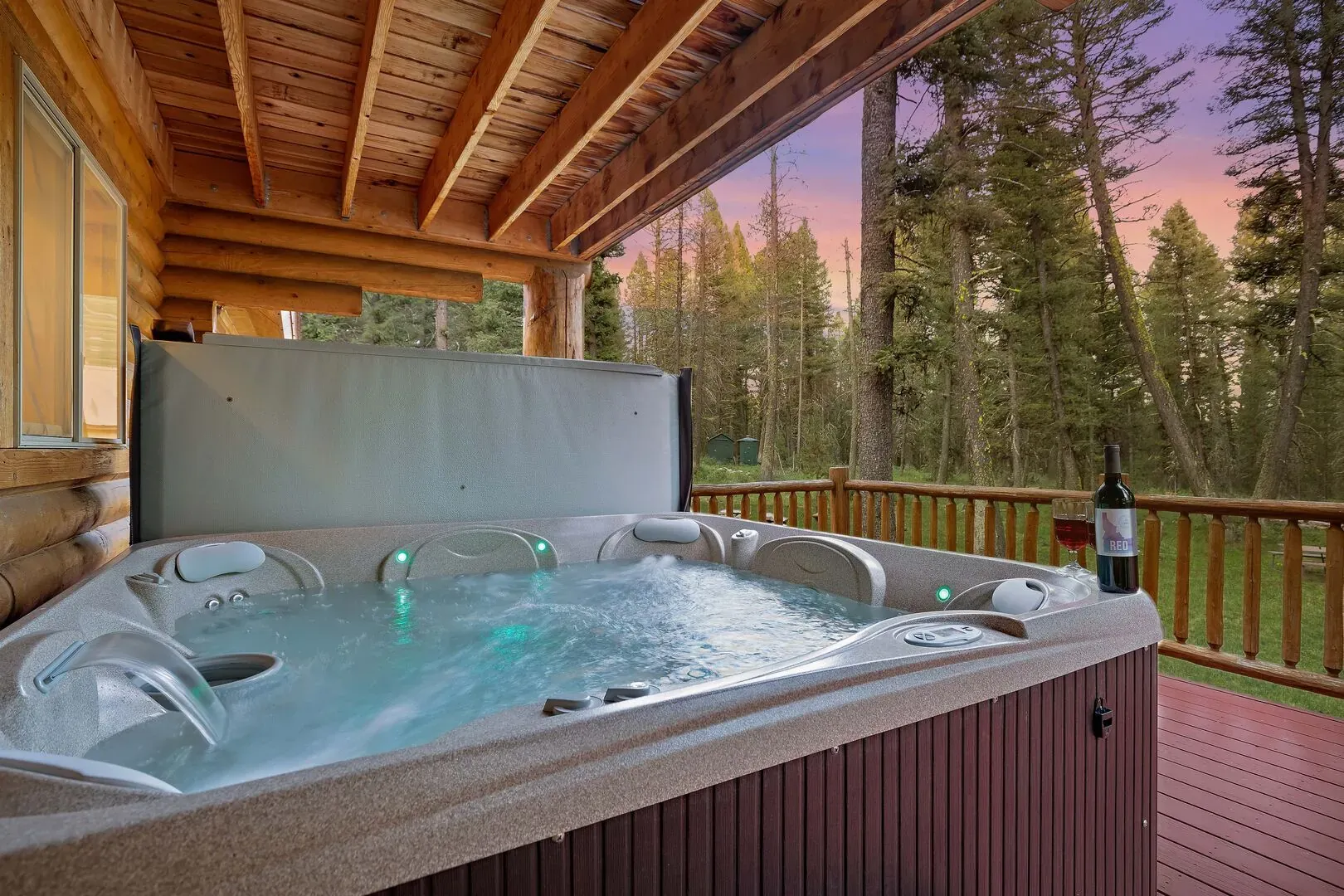 Outdoor hot tub area with privacy screens