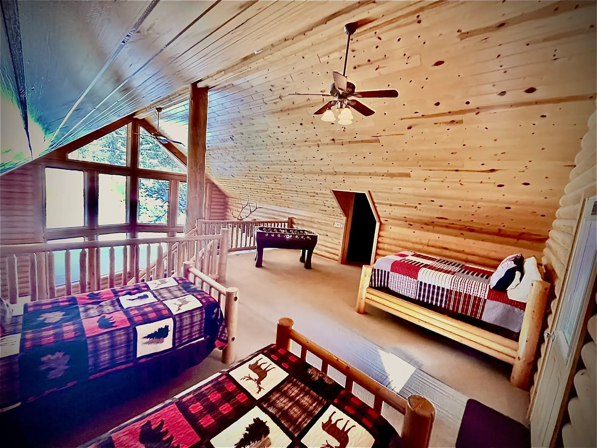 Three beds in the loft with access to a balcony with wooded views