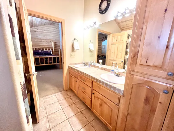 Master bathroom with a tub/shower, toilet, and two vanities with plenty of storage