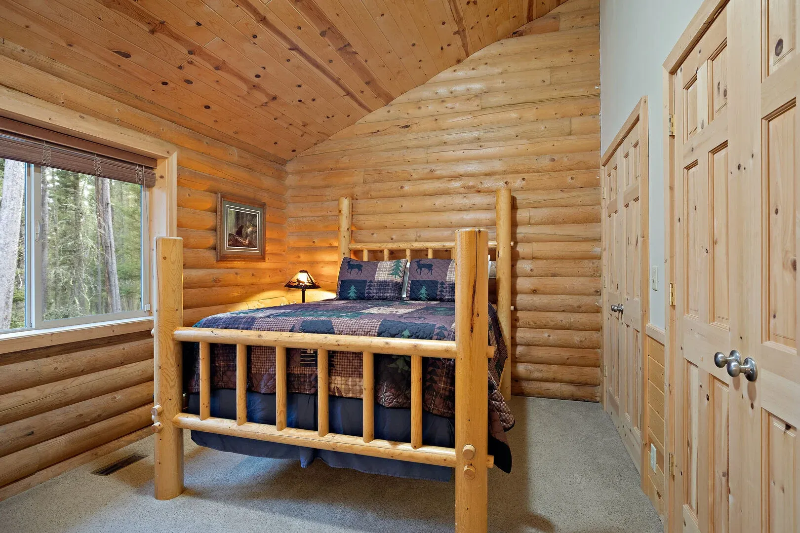 Master bedroom features a cozy log bed, mirror, and drawers with extra-large closet