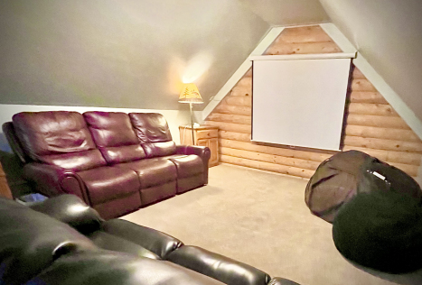 Supersize bean bag and big projector screen with Roku — your own private movie lounge