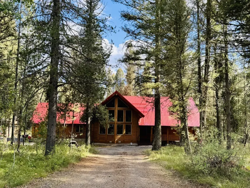 Lodgepole Pines Retreat cabin in Island Park Idaho surrounded by snow-covered pine trees