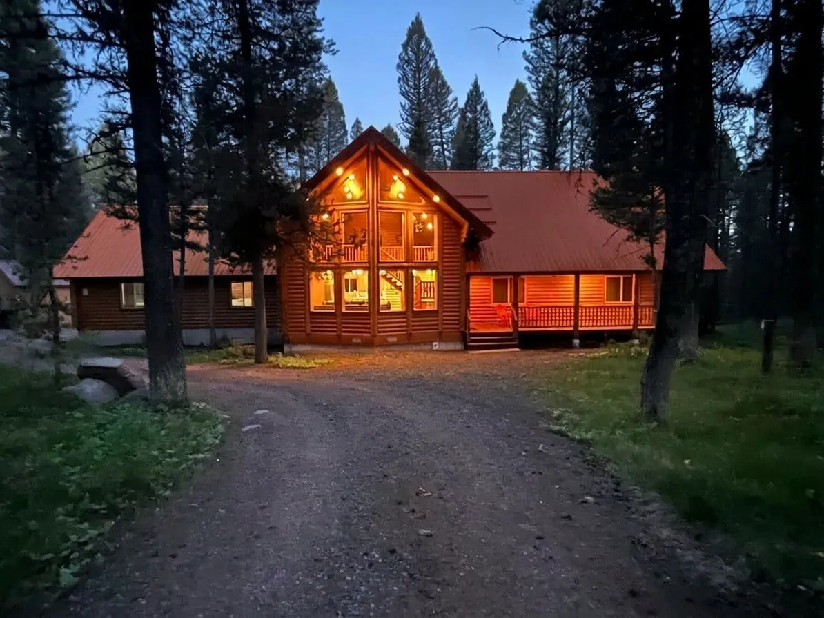 Lodgepole Pines Retreat cabin in Island Park Idaho surrounded by snow-covered pine trees