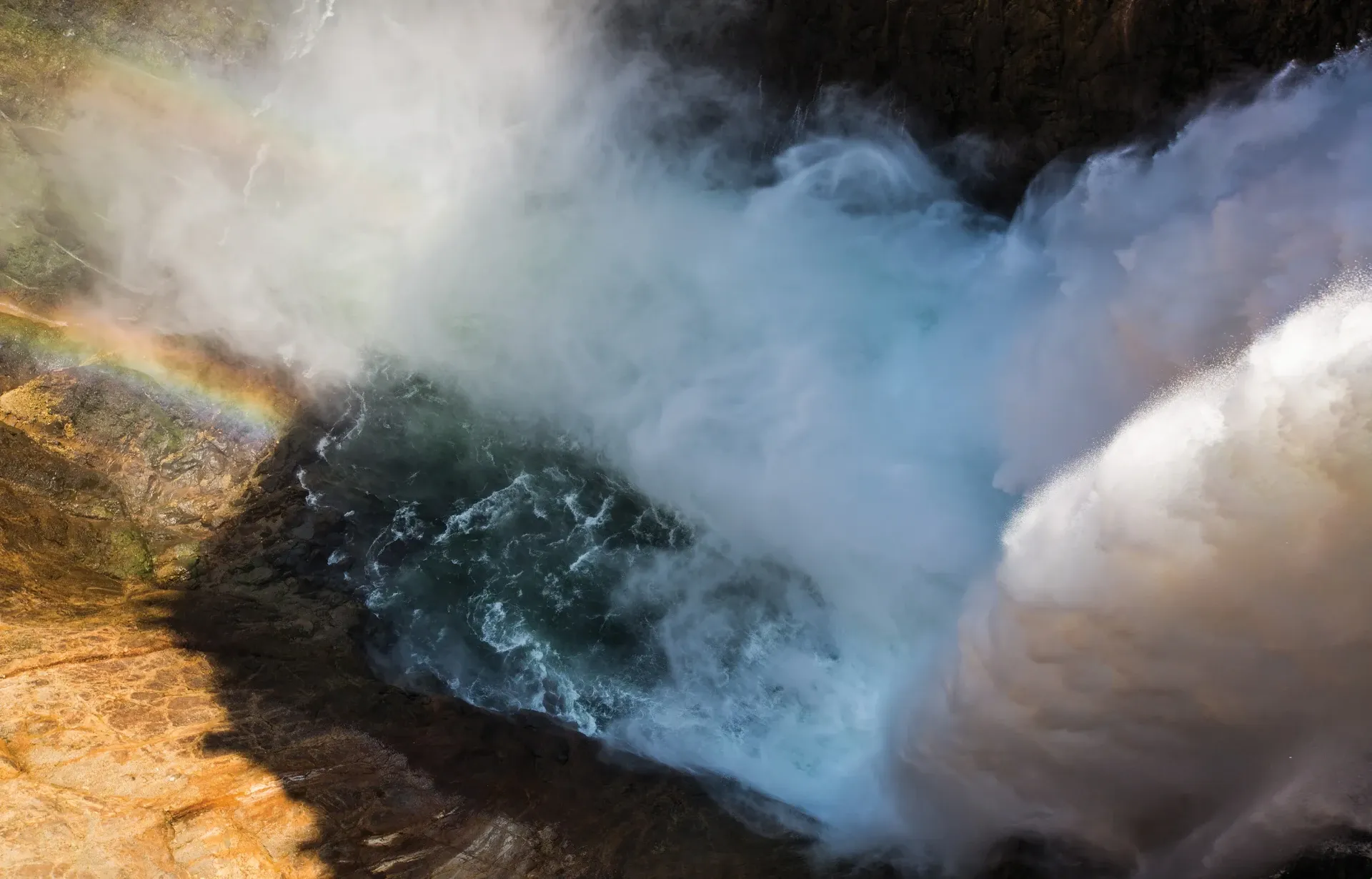 Rainbow at the Brink of the Lower Falls in Yellowstone