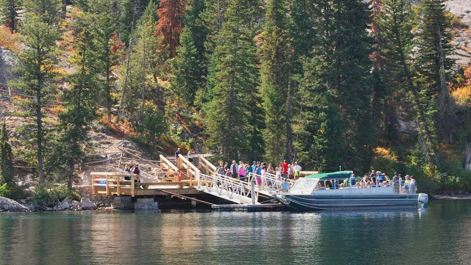 Shuttle boat on Jenny Lake with Teton mountains behind
