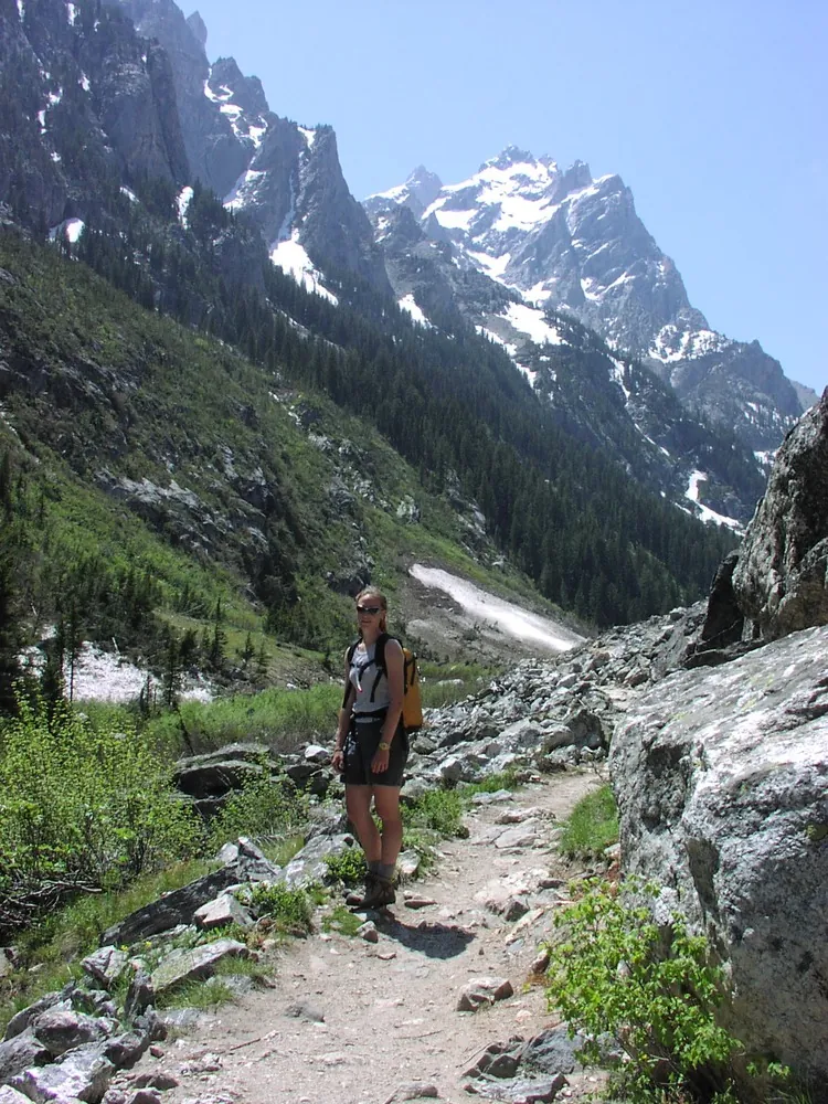 Hikers in Cascade Canyon with Mt. Owen towering above